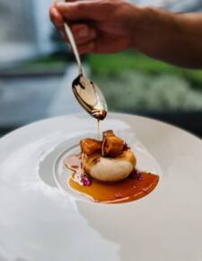 Exquisite French cuisine dish drizzled with aromatic brown sauce, perfect for an elegant meal