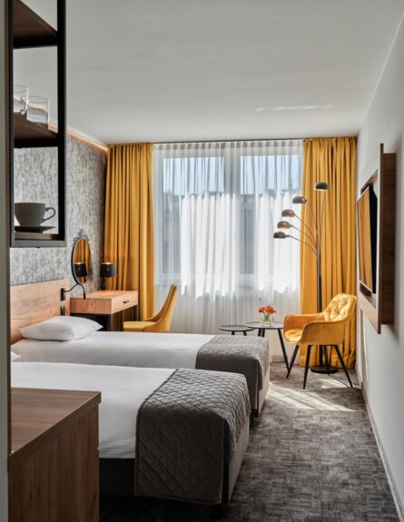 Elegant double room with cozy decor, vanity, and balcony, perfect for relaxation