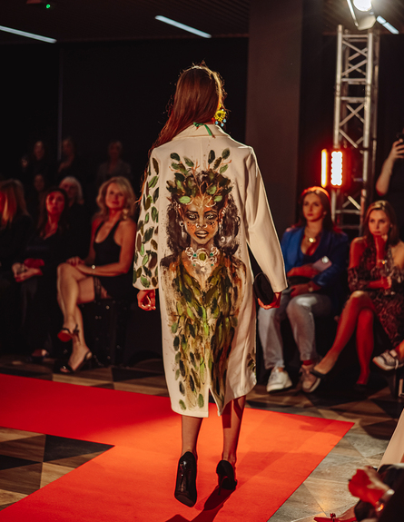 Back of an embroidered coat by a renowned designer showcased on the runway