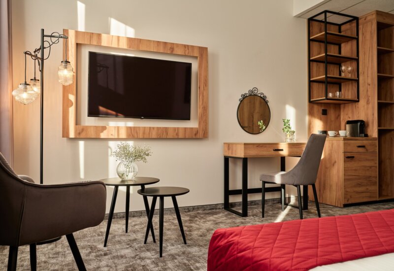 Room at Garni Hotel combining comfort with modern design.