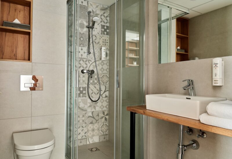bathroom at Garni Hotel with a spacious shower