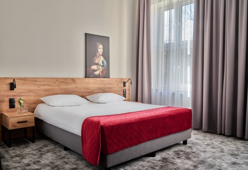 Very comfortable bed in a spacious hotel room.