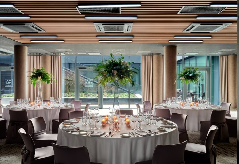 Arranged table for a group in the glass-walled restaurant Sobre de la Mesa
