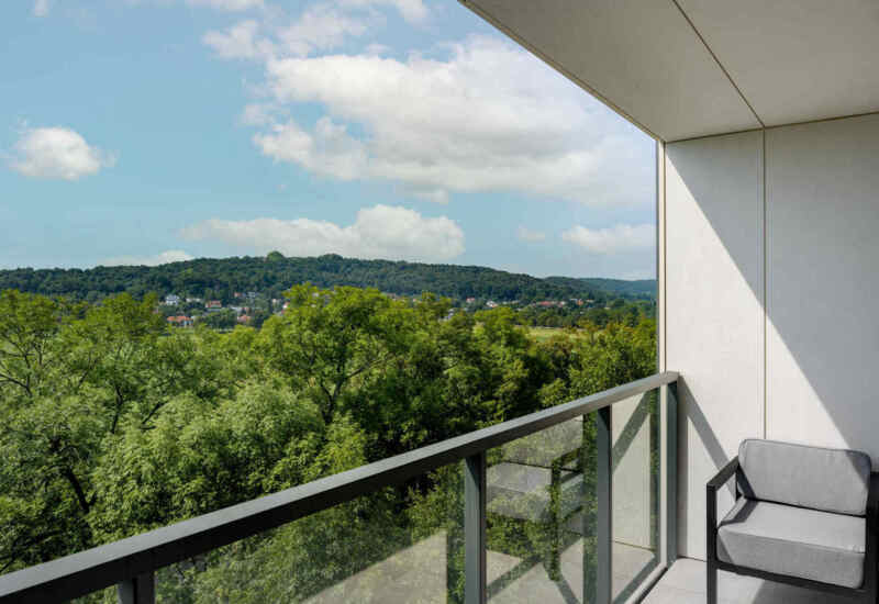 View of the greenery surrounding the hotel from the room's balcony – a peaceful and natural setting