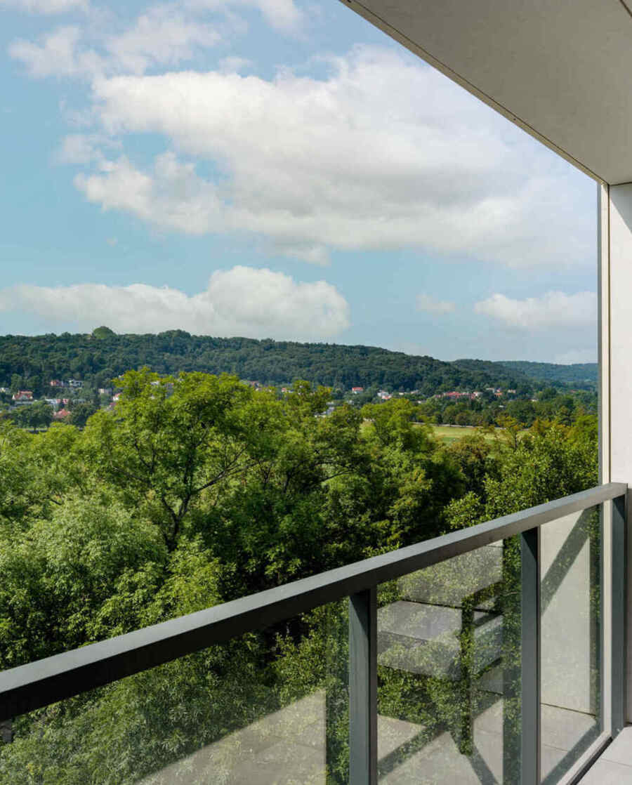 View of the greenery surrounding the hotel from the room's balcony – a peaceful and natural setting