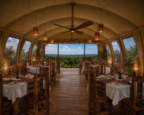 Tented fine-dining room with rustic wooden tables, lantern lighting and open front overlooking lush treetops and distant horizon.