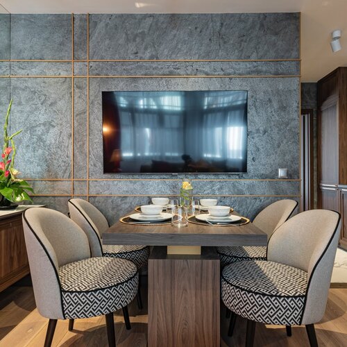 View of the dining table and television on the wall.