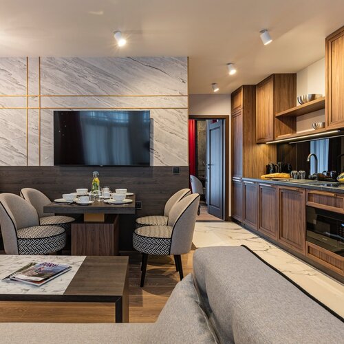 Living room with a sofa, coffee table and dining area in the corner.