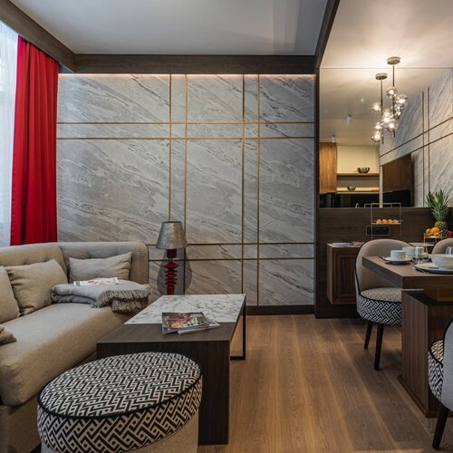 Living area with a sofa, coffee table and wall-mounted television.