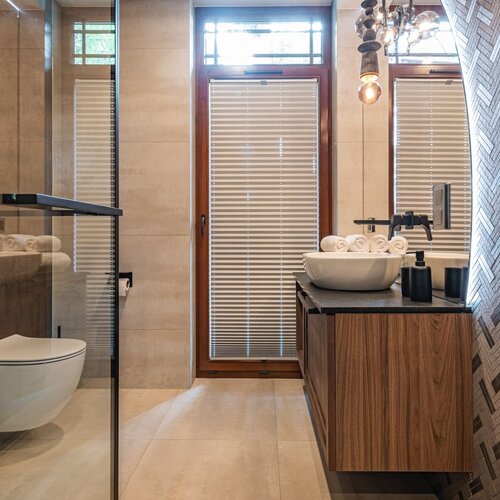 Bathroom with shower cubicle and washbasin with mirror.