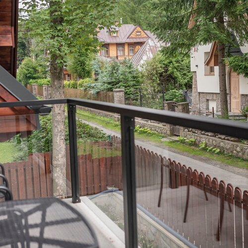 Balcony with glass balustrade and a view of neighbouring buildings.
