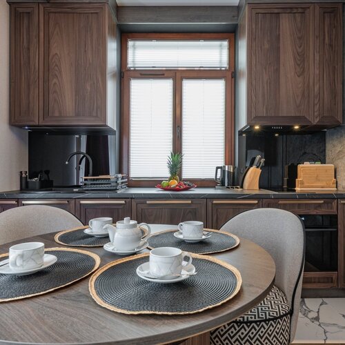 A table set for coffee with a view of the kitchenette.