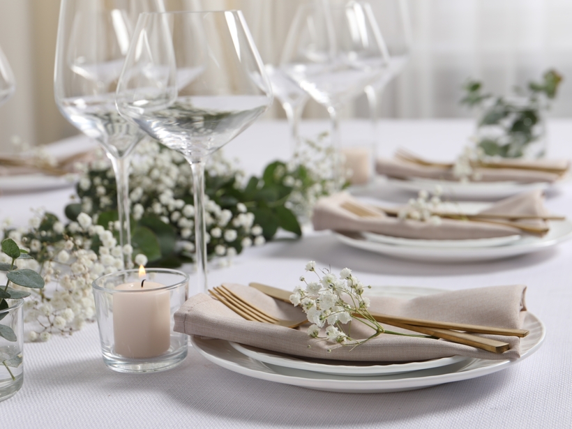 Decorated white table with flowers in rustic style at an elegant event