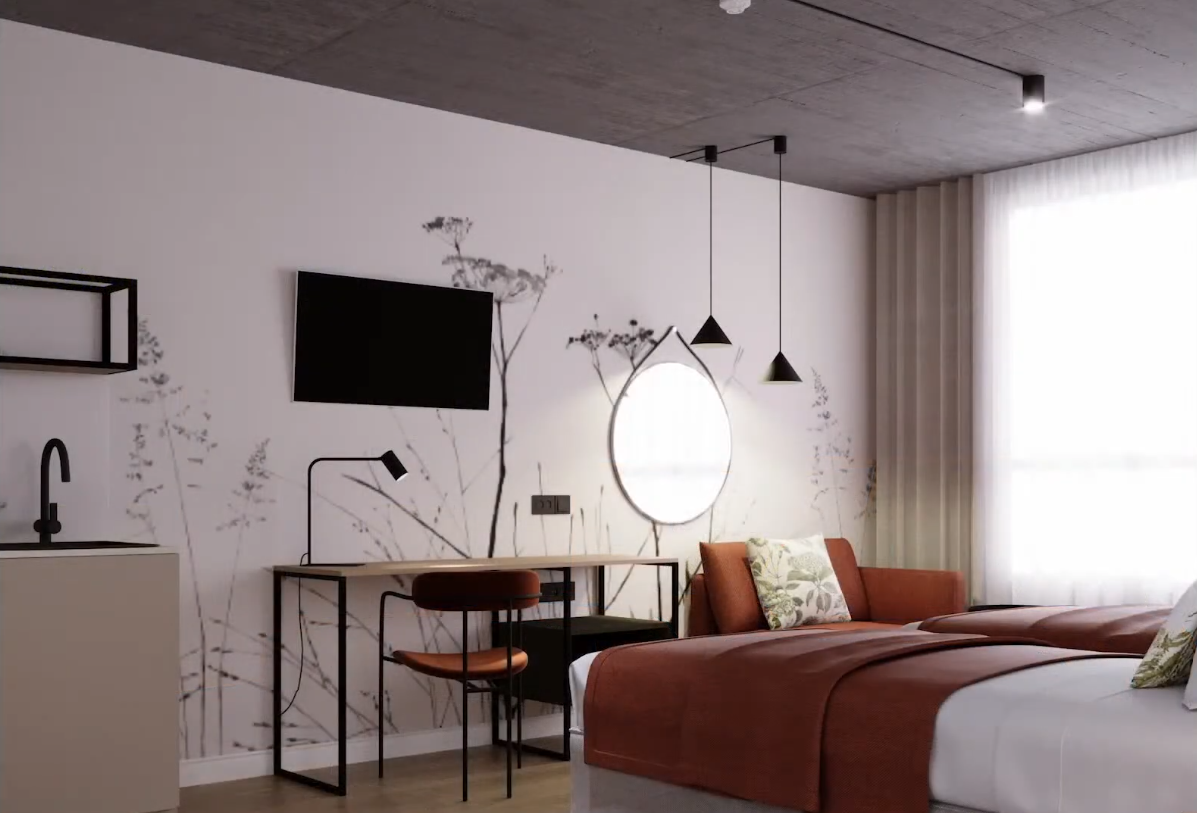 Nowoczesny pokój hotelowy: dwa łóżka z rdzawymi narzutami, kanapa, biurko, podświetlane okrągłe lustro, TV i duże okno z firaną