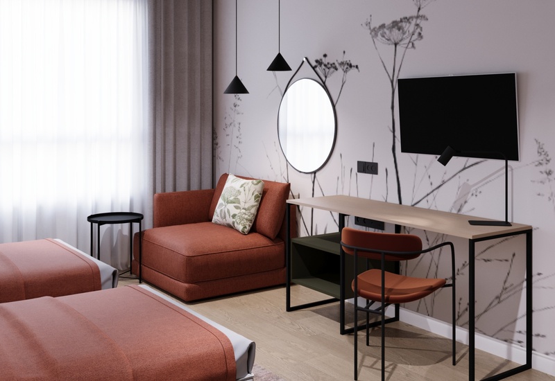 Przytulny pokój hotelowy z dwoma łóżkami, ceglastą leżanką, biurkiem roboczym, TV, okrągłym lustrem i roślinną tapetą.