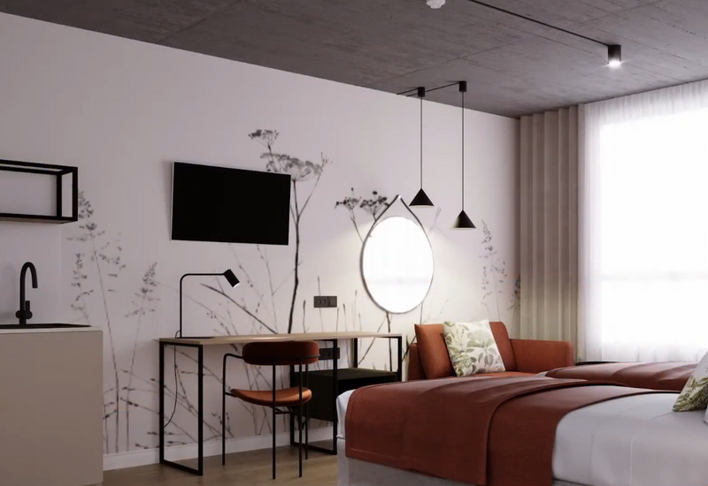 Nowoczesny pokój hotelowy: dwa łóżka z rdzawymi narzutami, kanapa, biurko, podświetlane okrągłe lustro, TV i duże okno z firaną