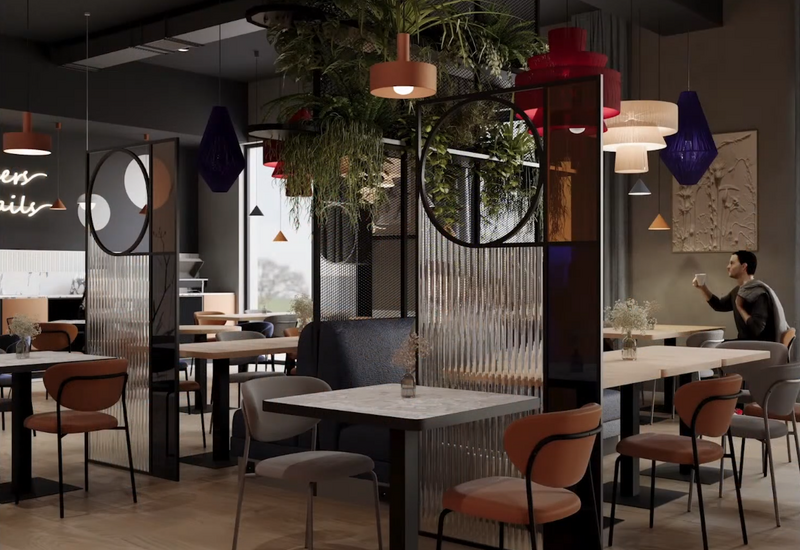 Stylowa hotelowa kawiarnia z marmurowymi stolikami, wygodnymi krzesłami, przegrodami, wiszącą roślinnością, klimatycznymi lampami i gościem z kawą.