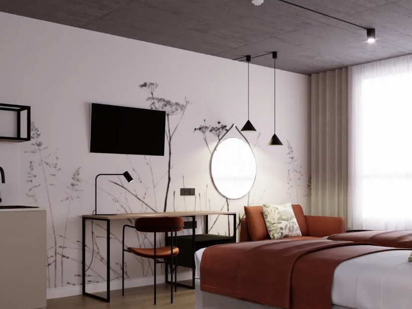 Nowoczesny pokój hotelowy: dwa łóżka z rdzawymi narzutami, kanapa, biurko, podświetlane okrągłe lustro, TV i duże okno z firaną