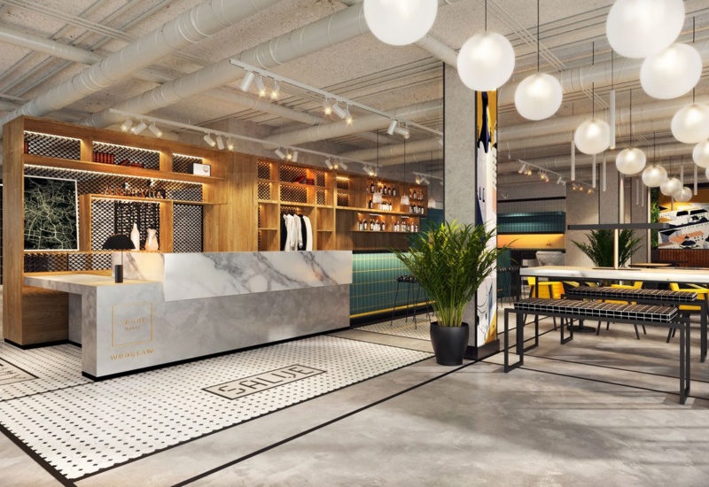 Modern hotel reception with white marble desk, wooden shelves, large potted plant, and stylish round pendant lights.