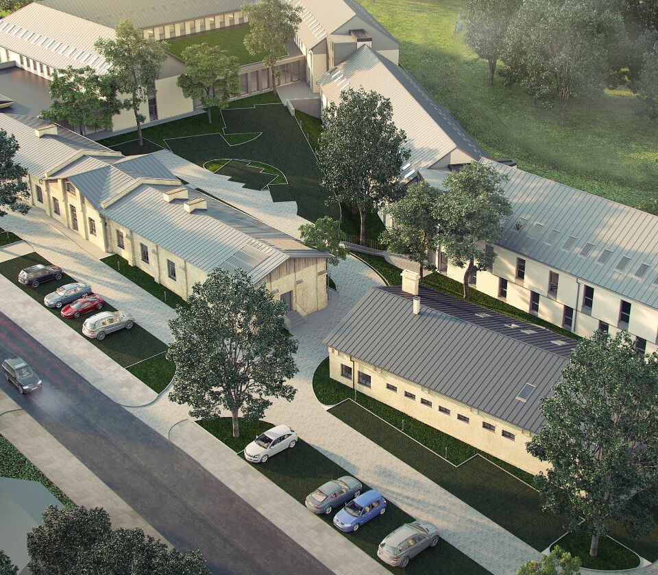 Nowoczesny hotel z kilkoma budynkami, dużym parkingiem i zielonym patio otoczonym drzewami