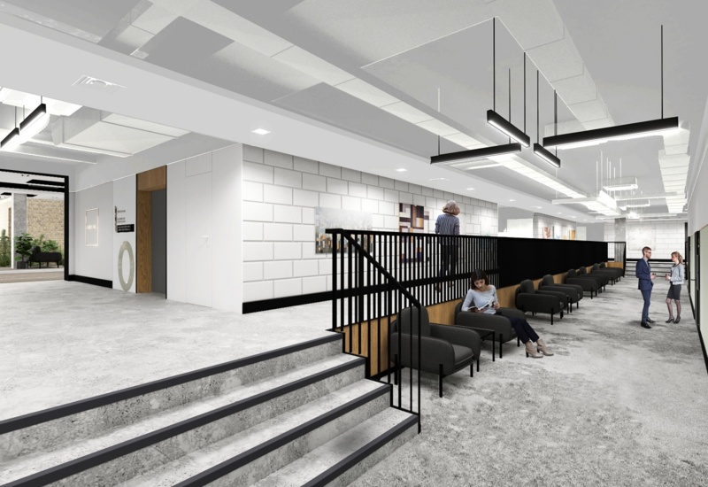 Modern hotel lobby with concrete steps, black metal railing, rows of comfy armchairs, pendant lights and guests chatting.