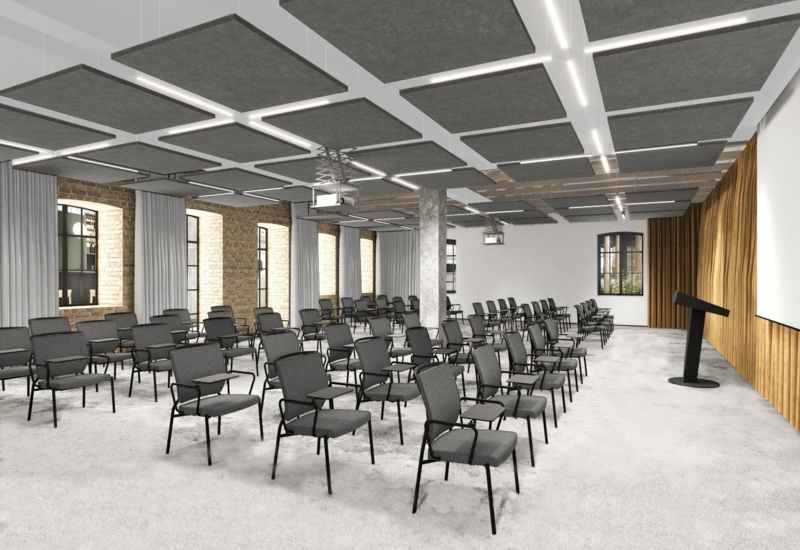 Modern hotel conference room with rows of chairs with writing tablets, podium, suspended acoustic ceiling panels, projector and brick windows.