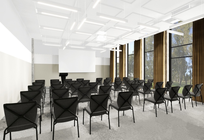 Modern meeting room with rows of black chairs facing a podium and screen, floor-to-ceiling windows with gold curtains.