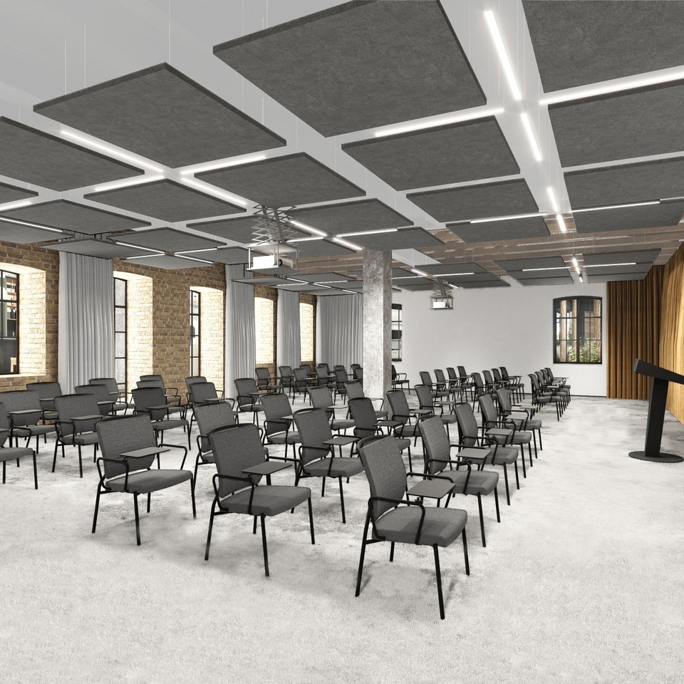 Modern hotel conference room with rows of chairs with writing tablets, podium, suspended acoustic ceiling panels, projector and brick windows.