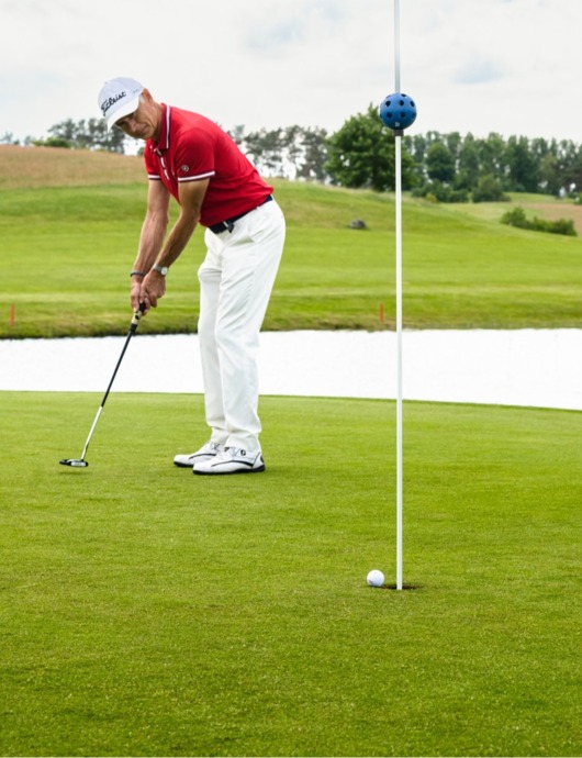 Mann locht ein auf dem Balmer See Golfplatz auf Usedom