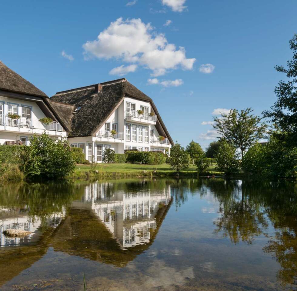 Haus Gothensee in der Reflektion des Teiches des Resort Balmer See auf Usedom