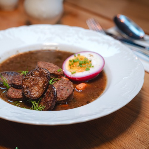 Polish sour rye soup with sausage and egg – traditional dish at Starodworcowa