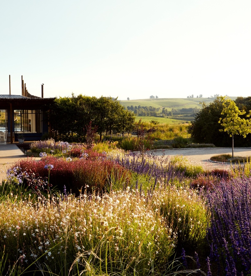 Garden pavilion with open terrace and reflecting pool, framed with lavender beds, wildflower borders and countryside views