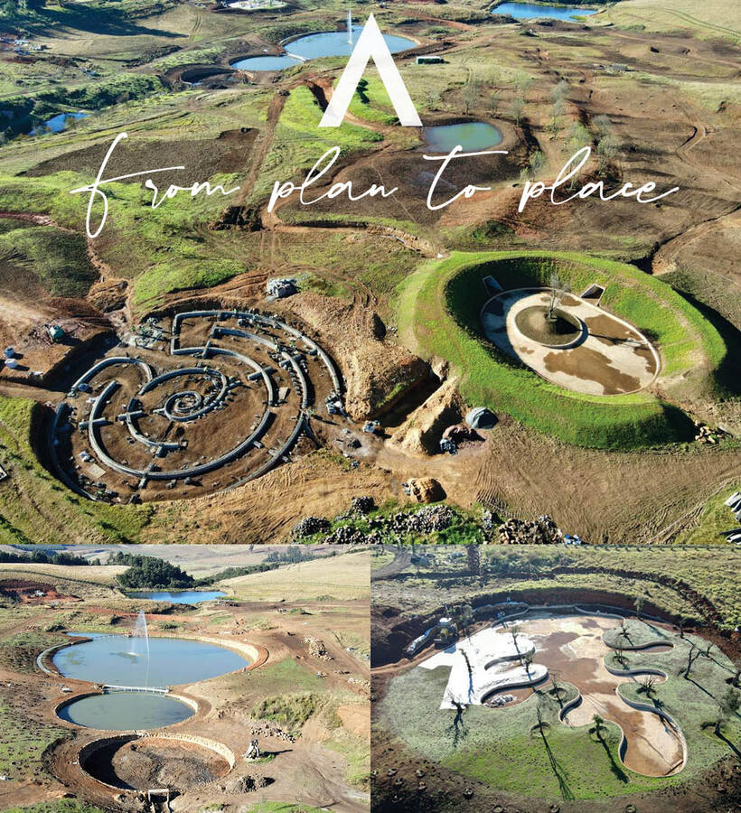 Aerial view of resort site under development with circular ponds, sculpted earth-berm pools, grassy terraces and water features