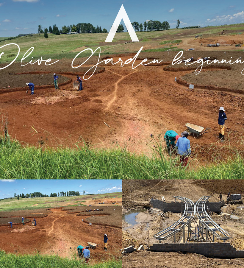 Workers shaping circular planting beds and paths on a sunlit hillside, wheelbarrow and garden frames amid grassy resort grounds
