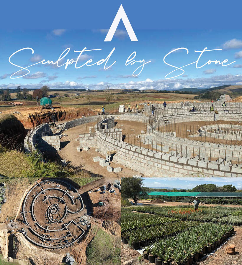 Curved spiral stone walls under construction on rural hills, workers amid site and nearby rows of potted succulents.