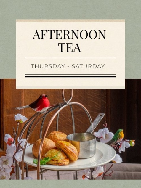 Elegant afternoon tea service with fresh scones, clotted cream, and floral decor, offered Thursday through Saturday