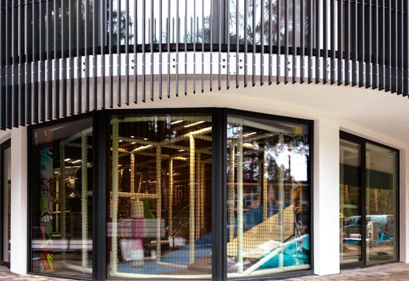 Nowoczesne centrum zabaw dla dzieci z dużymi oknami i bezpiecznymi, kolorowymi zjeżdżalniami i drabinkami