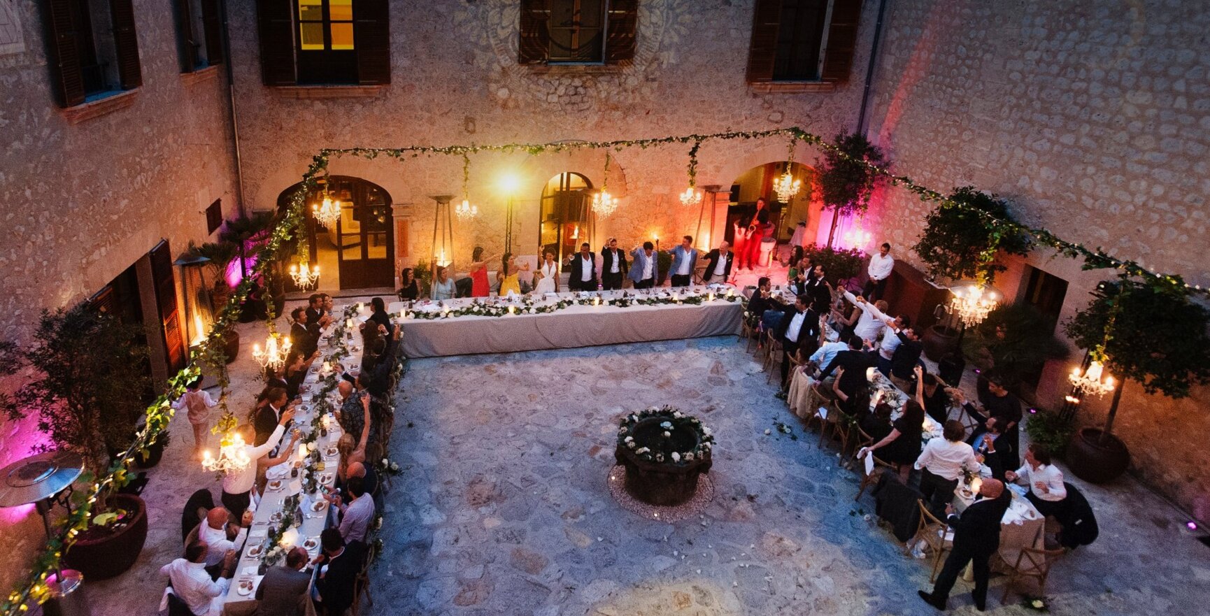 Celebración romántica con mesas largas en un hermoso lugar de bodas de Mallorca