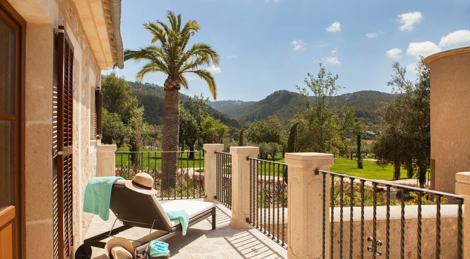 Sunny terrace of a suite at a Mallorca wedding venue with a woman taking a sun bath