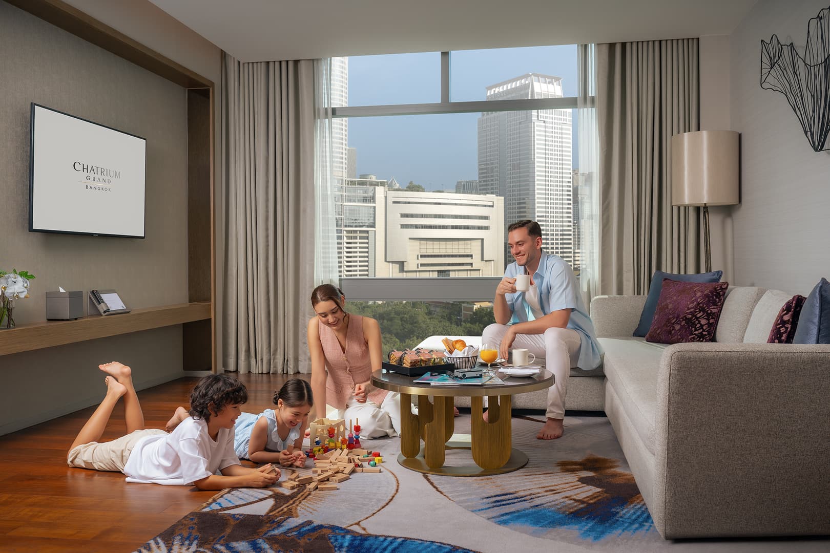 Family enjoying a spacious suite at Chatrium Grand Bangkok Residences near Siam Paragon