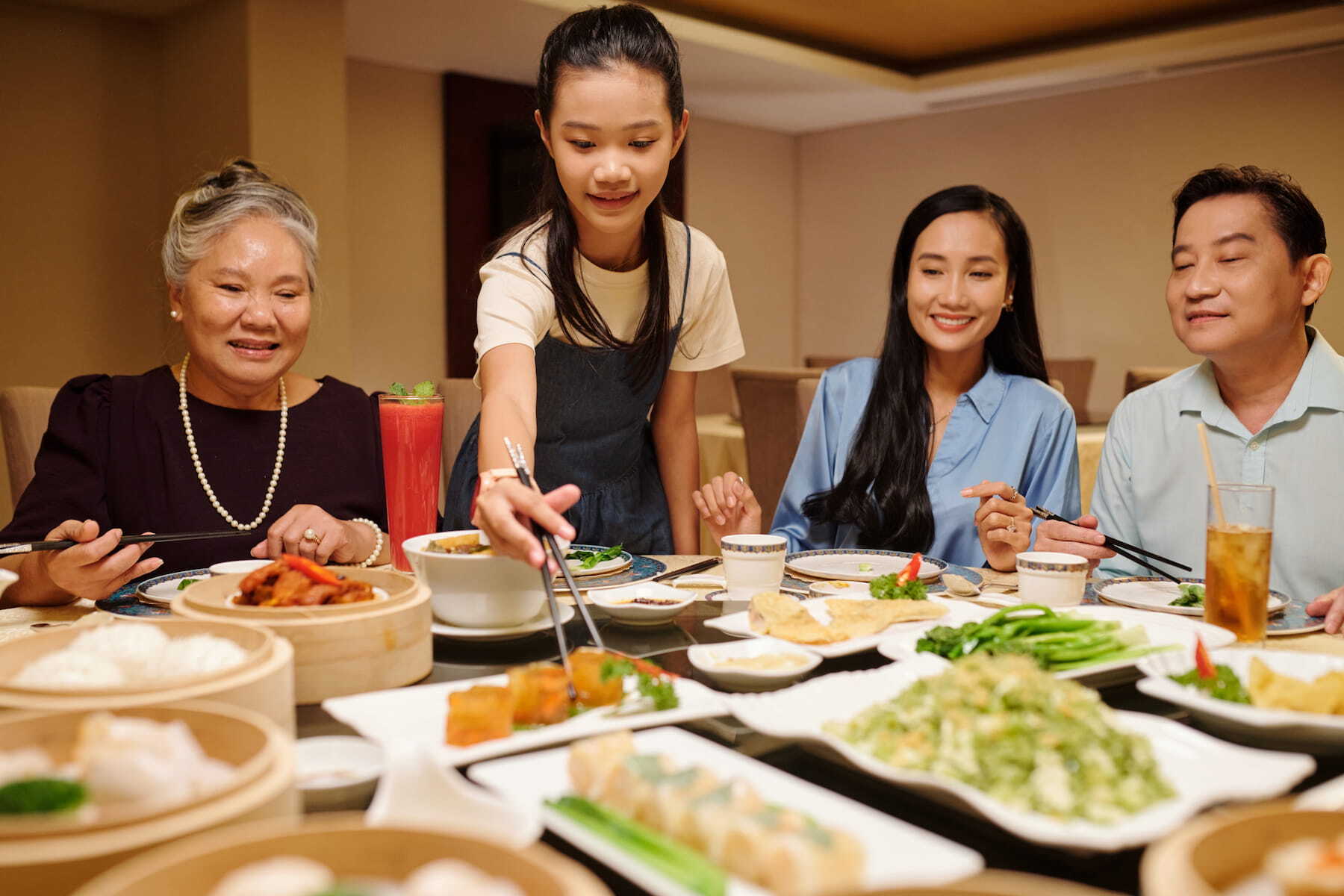 A family enjoying dinner together at an elegant hotel restaurant in Bangkok.