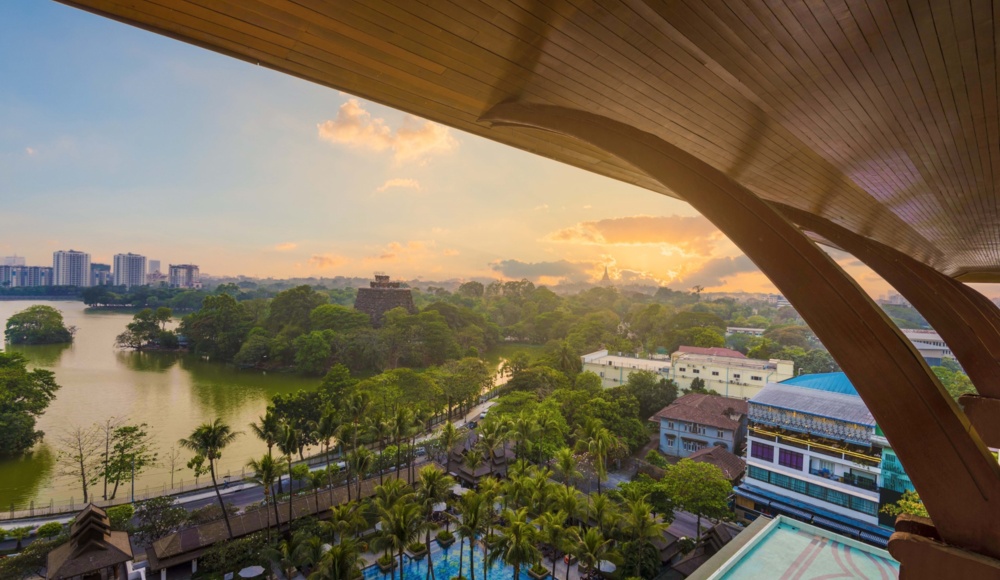 A panoramic view from a building's rooftop, showcasing a serene lake.