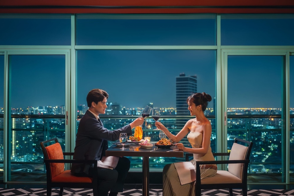 A couple enjoying a romantic dinner at Silver Waves by Boon