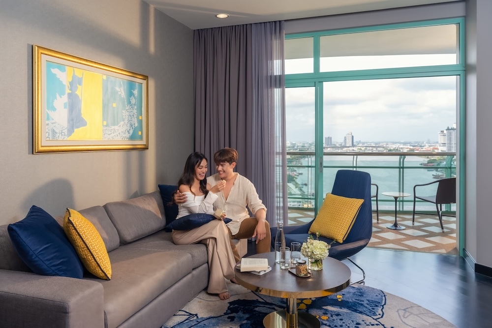 A couple in a suite with a river view at Chatrium Hotel Riverside Bangkok