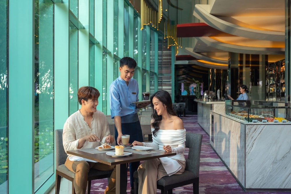 A couple enjoying coffee and pastries the the Lobby Lounge at Chatrium Hotel Riverside Bangkok