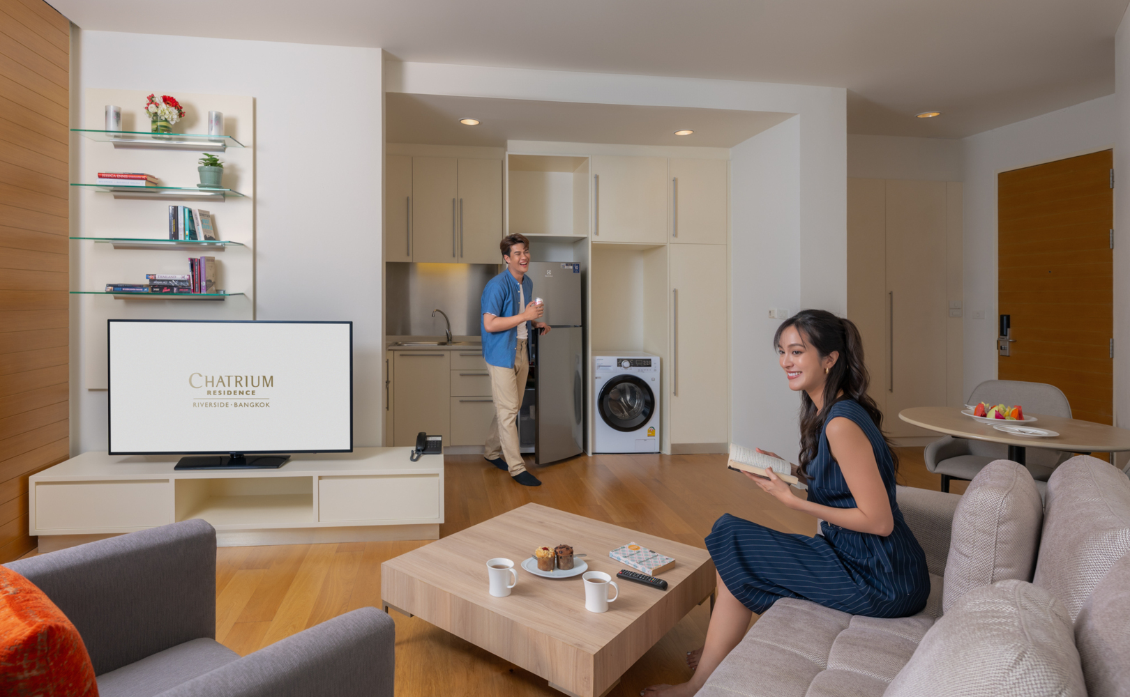 A woman sitting comfortably on a couch, looking relaxed and engaged in her surroundings.