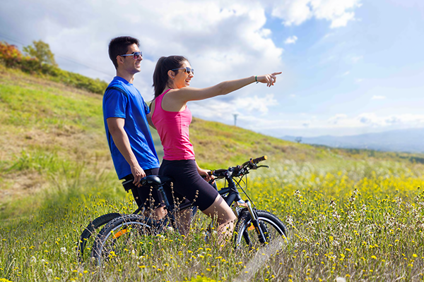 A man and a woman point at an unseen object, suggesting they are sharing an observation