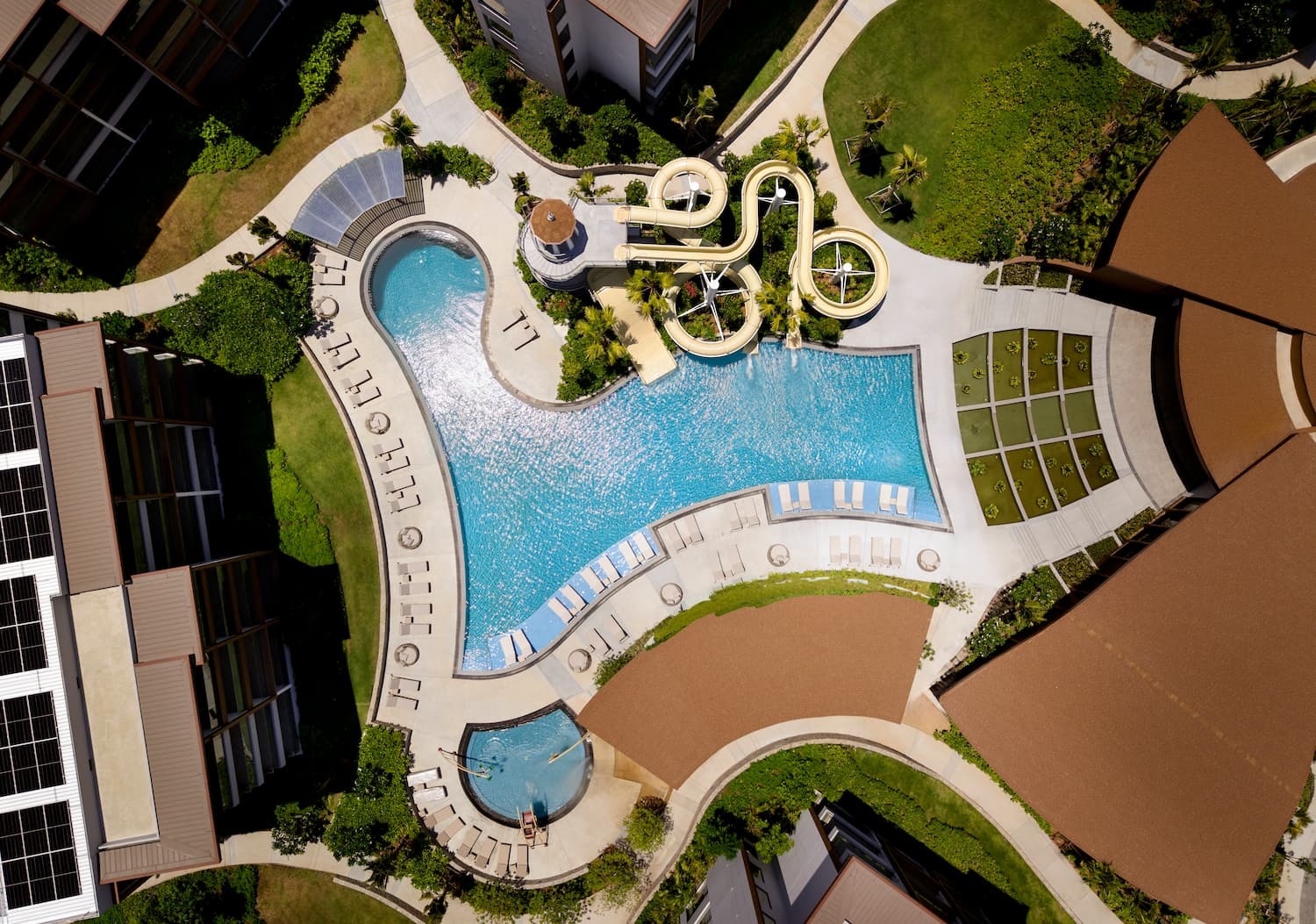 Aerial view of the pool and water slides at Chatrium Phuket Rawai resort