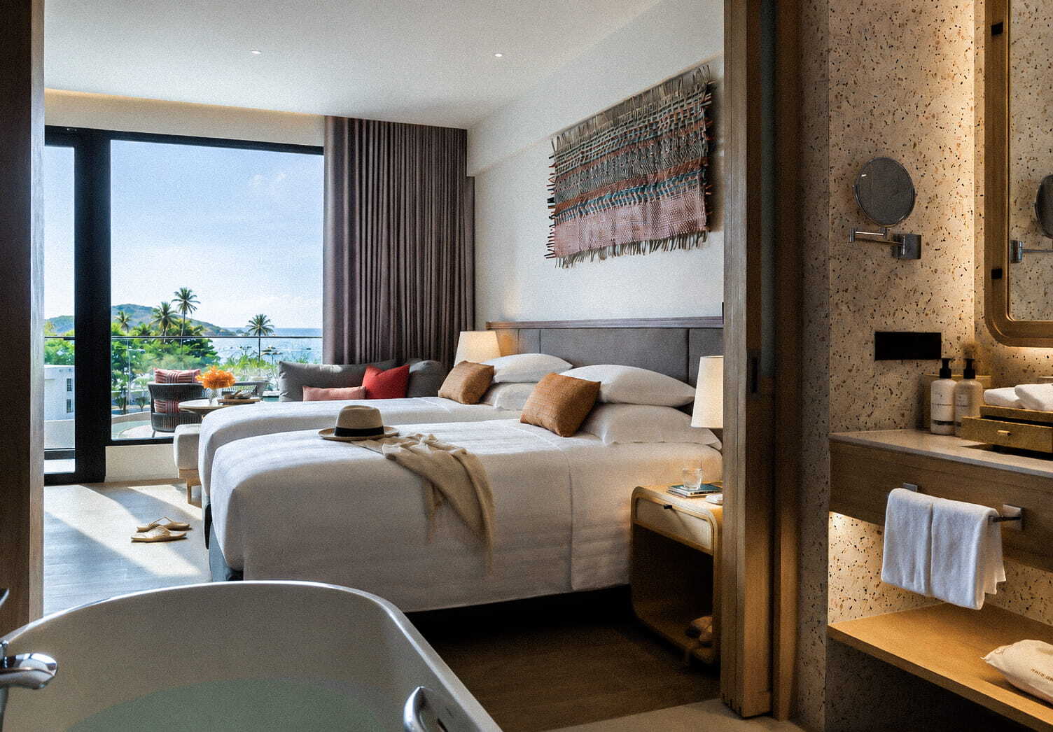 Deluxe sea-view twin room at Chatrium during one of the best times to visit Phuket, Thailand.