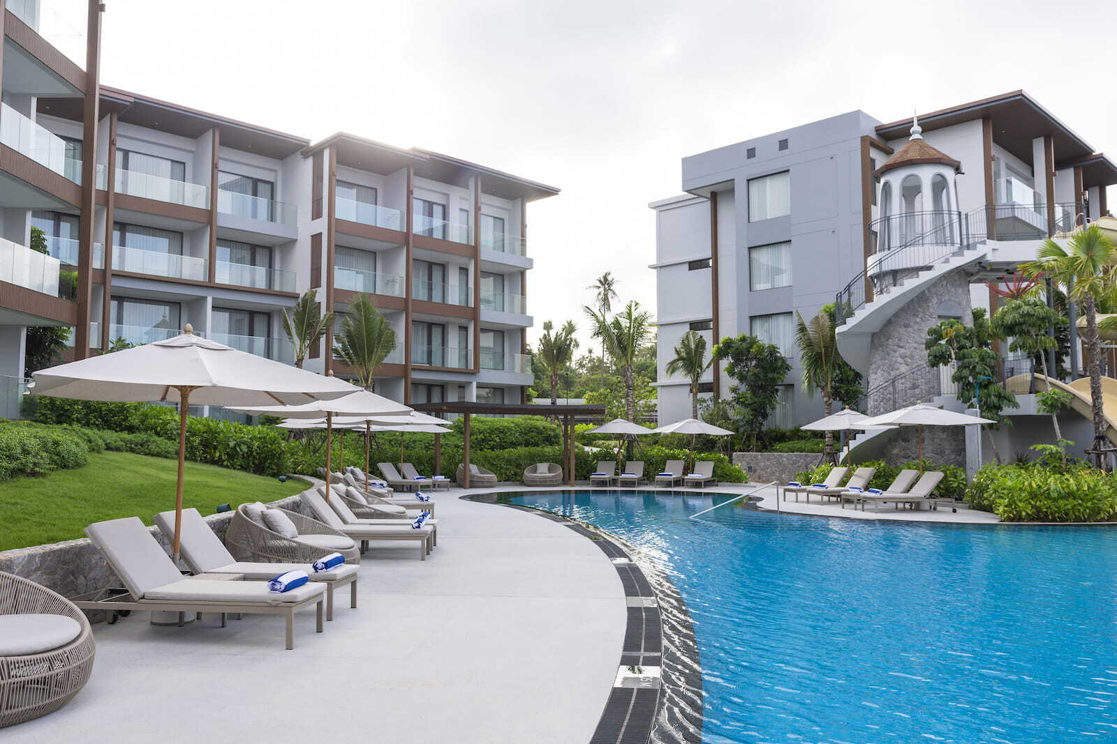 Pool, water slides and loungers at Chatrium Phuket Rawai, a team-building venue in Phuket